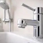 Signs of Hard Water at Home (And How to Spot Them) Mineral scale buildup on a bathroom faucet showing signs of hard water